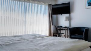 Tempat tidur dalam kamar di Metropol