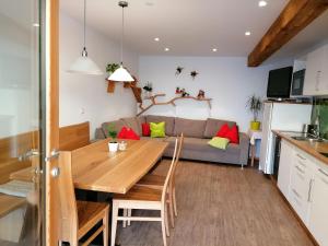 a kitchen and living room with a table and a couch at Hofer Hof in Feldthurns