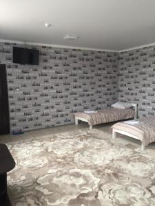 a room with two beds and a wall at Gostinyy dvor in Elista