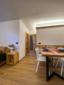 a dining room with a table and a couch at Casa Cecilia in Bormio