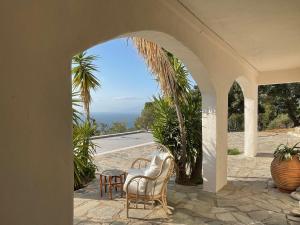 a patio with chairs and a view of the ocean at SEA BREEZE STUDIO in Loutraki