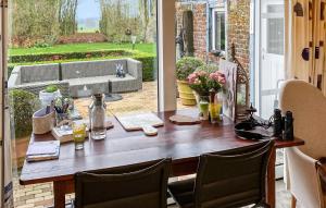 a wooden table on a porch with chairs and a tableablish at Stunning Home In Kemmel With Wifi in Kemmel