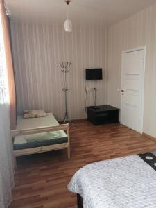a room with two beds and a television in it at Gostinyy dvor in Elista