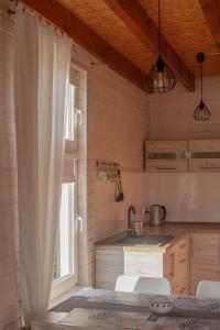 a kitchen with a table and chairs and a window at pod lipą in Ustka