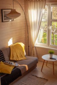 a living room with a couch and a window at pod lipą in Ustka
