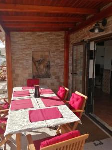 a table with pink pillows and chairs on a patio at Varandas da Serra II in Vila Franca de Xira +58 photos