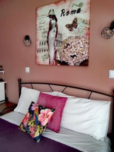 a bedroom with a bed with a picture on the wall at Nancy Studios in Skala Kallonis