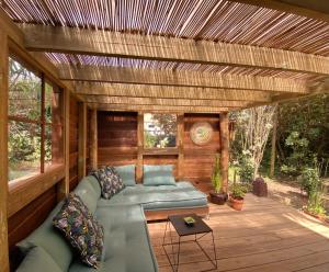 a covered porch with a couch and a table at La Crampotte de Bidart, proche Océan in Bidart