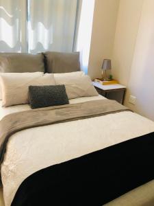 a bedroom with a large bed with two pillows at Umhlanga Ridge self-catering apartment in Durban