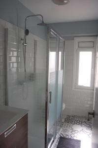a bathroom with a shower with a glass door at El Apartamento de Marta in A Coruña