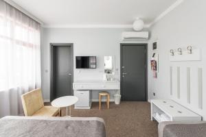 a white room with a bed and a table and a sink at Delight Deluxe Port in Antalya