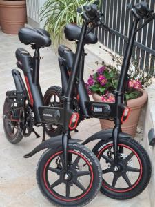 two black bikes parked next to a pot of flowers at La Corte di Kate in Biograd na Moru