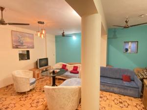 a living room with a couch and a table at Sukh Villas - Best Budget villa in Karjat in Karjat