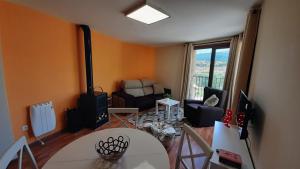 a living room with a table and a couch at Apartamento Las Vistillas in Valdelinares