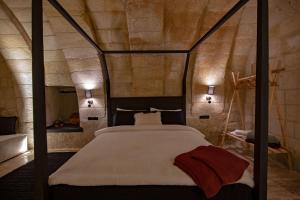A bed or beds in a room at Sato Cave Hotel