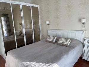 a bedroom with a bed with two pillows on it at Rauhan Marinella Apartments in Imatra