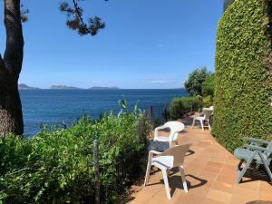 a patio with chairs and a view of the ocean at Casas 1ª línea ría de Vigo in Vigo