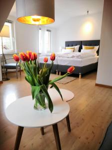 a living room with a vase of flowers on a table at Ferienhof Trapp in Ellringen