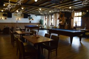 a restaurant with tables and a pool table at Hotel Cafe 't Zonneke in Oosterhout