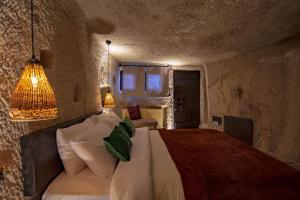 A bed or beds in a room at Sato Cave Hotel