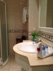 a bathroom with a white sink and a shower at Balcon de Jandia Tipo A in Morro del Jable