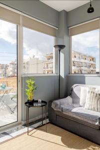 a bedroom with a bed and a large window at Bango Loft Chalandri, with private parking in Athens