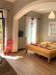 a bedroom with two beds and a red chair at Villa Angelina Guest House in Cannero Riviera
