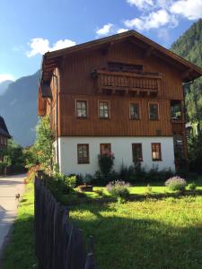 a large wooden house in the middle of a street at Appartement Emilia in Hallstatt