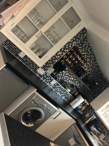 an overhead view of a kitchen with a washing machine at City Centre Victorian Terrace in Cardiff