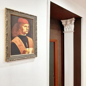 a painting of a man with a hat on a wall at Хостел Арбат 29 in Moscow