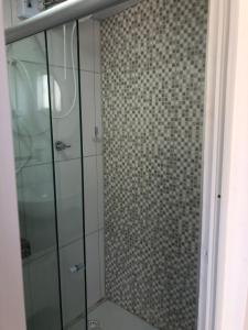 a bathroom with a shower with a glass door at Toca da Villa in Fernando de Noronha