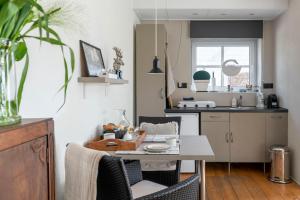 a kitchen with a table and chairs and a kitchen with a counter at d'Ouwe stal in Axel +9 photos