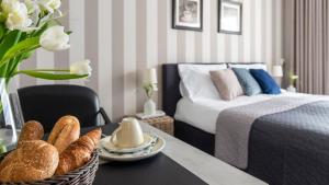 a bedroom with a bed and a table with a basket of bread at Suite 16 in Axel