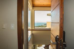 a view from the hallway of a house with a window at Casa Mirador Boutique Hotel in Búzios