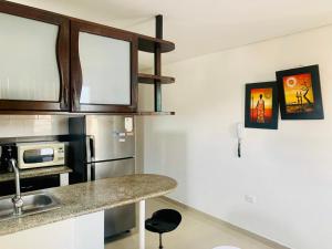 a kitchen with a counter top and a refrigerator at Santa Marta Apartamentos - Brisas Marina in Santa Marta