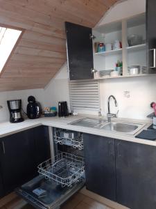 a kitchen with a sink and a dishwasher at Ferienwohnung Beate 2 in Ziemetshausen