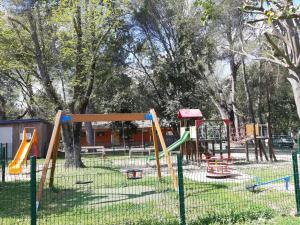 a playground with a bunch of play equipment in a park at Camping de la Chapelette in Saint-Martin-de-Crau