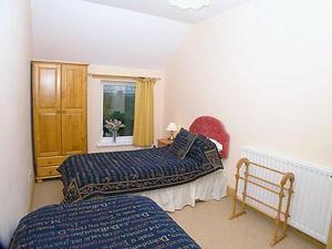 A bed or beds in a room at Bees Cottage 