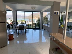 a kitchen and dining room with a view of the ocean at Casa Doma Orsova in Orşova