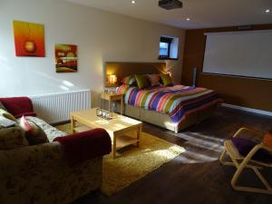 a living room with a bed and a couch at 'Le Studio' in Inverness