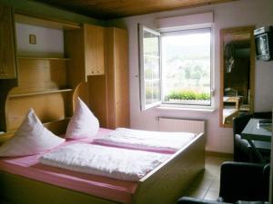 a small bed in a room with a window at Mosel Panorama in Zell an der Mosel