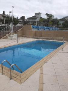 una gran piscina de agua azul en un edificio en Casa de campo em resort com banheiras água termal en Santo Amaro da Imperatriz