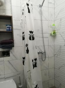 a bathroom with a shower curtain with cats on it at Апартаменты на Соборном с видом на парк in Zaporozhye