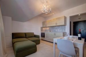 a living room with a couch and a table at Pinewood Apartment Borovets in Borovets