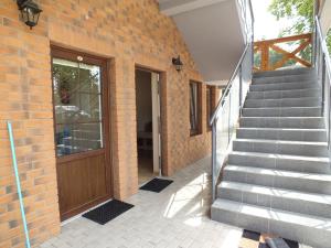 a brick building with a staircase next to a door at Apartament Angelit in Rowy