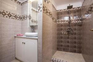 a bathroom with a shower and a sink at Kamara Antica Apartments in Rhodes Town