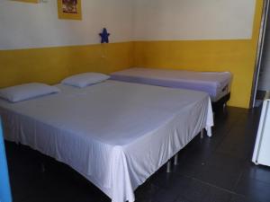 เตียงในห้องที่ Pousada Aldeia do Sossego