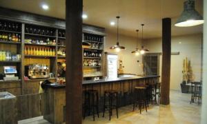 a bar in a restaurant with bar stools at Santa Bárbara in Sant Corneli de Cercs 