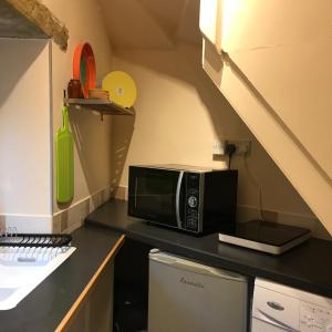 a microwave sitting on a counter in a kitchen at No.18 Holmfirth in Holmfirth