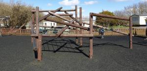 a wooden play structure in a playground at Port Haverigg Marina Village in Millom